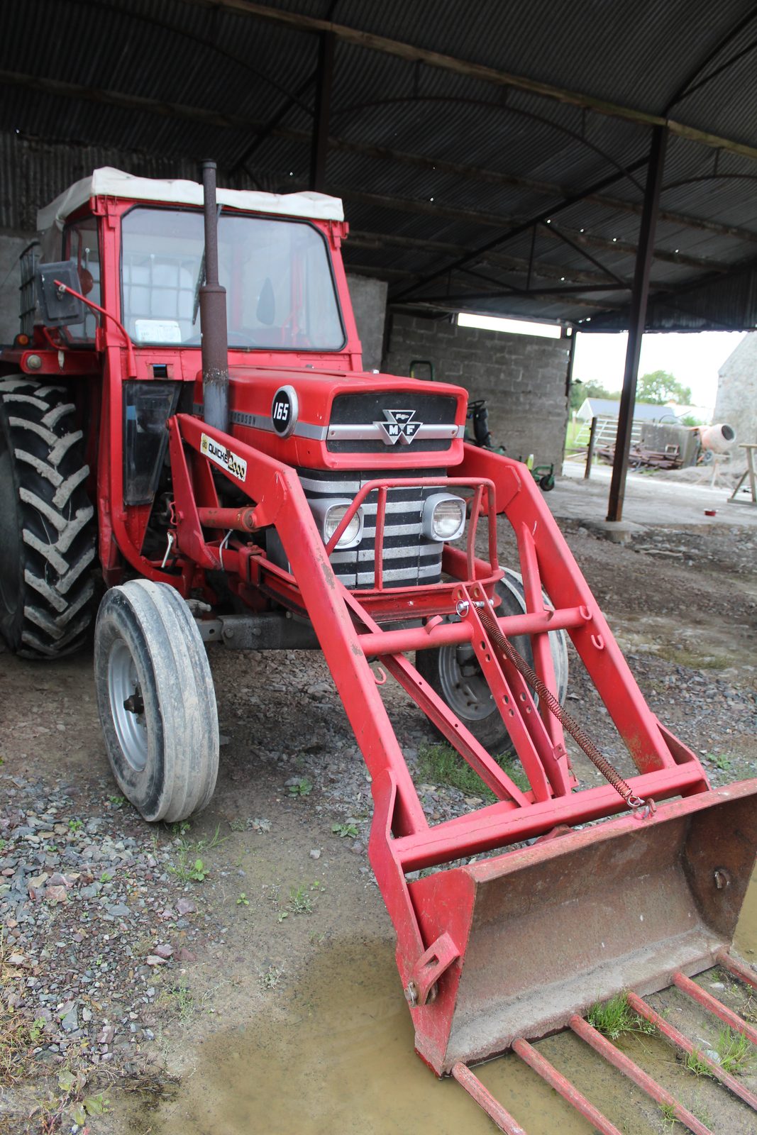 The farm’s red Massey Ferguson 165 parked in the shed